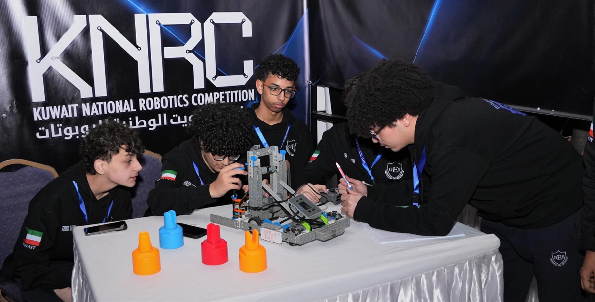 Students assembling a robot at the Kuwait National Robotics Competition