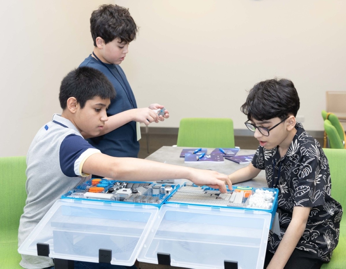Students building a robot during the Youth Power Tech Summer Camp